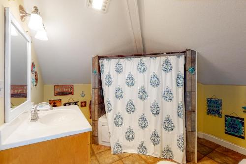 a bathroom with a sink and a shower curtain at Reel Living #3-AV in Avon