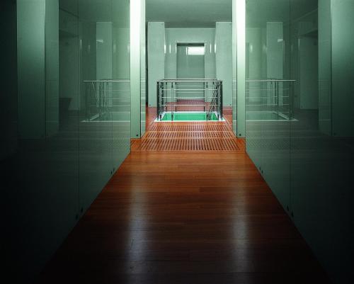 an empty hallway with a gate and a wooden floor at Le Sirenuse in Positano
