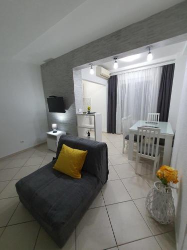 a living room with a couch and a table at Apartmani Matković in Sutomore