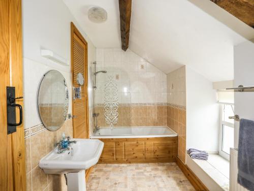 a bathroom with a sink and a bath tub at Bodlasan Groes House in Holyhead