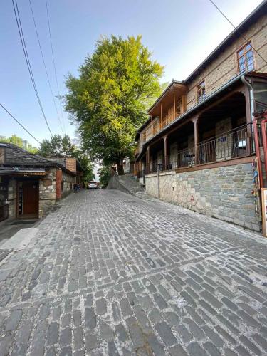 an empty cobblestone street in front of a building at 11 Luxury Apartments Metsovo. in Metsovo