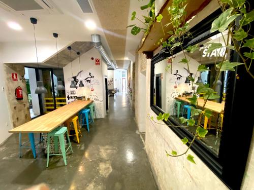 a restaurant with a long wooden table and chairs at ECO Hostel in Granada