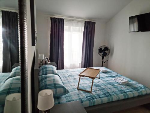 a bedroom with a bed with a table on it at Apartment Julija in Opatija