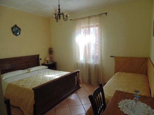 a bedroom with two beds and a table and a window at Bigotti in Fano