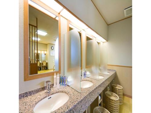 a bathroom with two sinks and two mirrors at Dogo Onsen Funaya - Vacation STAY 54201v in Matsuyama