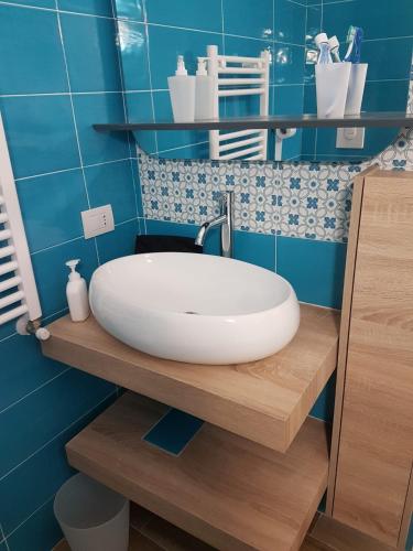 a bathroom with a white sink on a wooden counter at Rega Holiday House in Naples