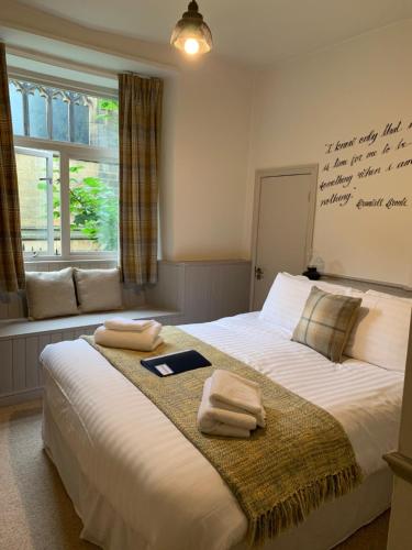 a bedroom with a large bed with towels on it at Black Bull Inn in Haworth