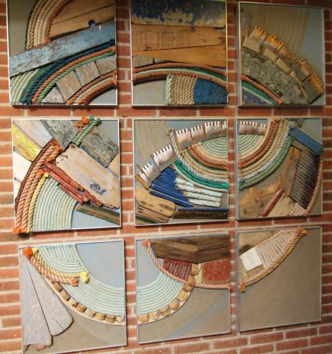 a group of mosaics on a brick wall at Sauntehus Castle Hotel in Hornbæk