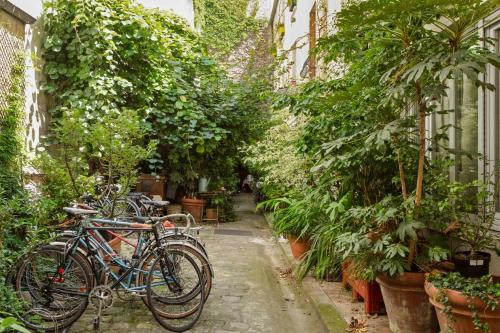 a group of bikes parked in a garden at Nice and modern 1br at the heart of Paris nearby Canal St-Martin - Welkeys in Paris
