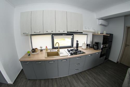 a kitchen with white cabinets and a counter top at apart bun in Oradea