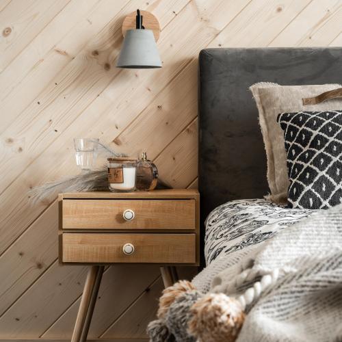 a bedroom with a bed and a nightstand with a nightstand at Folkova 21 - Apartamenty in Biały Dunajec