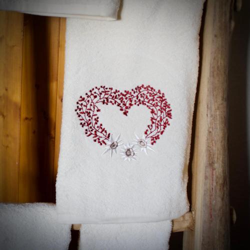 a towel with a heart drawn on it on a shelf at Rifugio Baita Gimont in Cesana Torinese