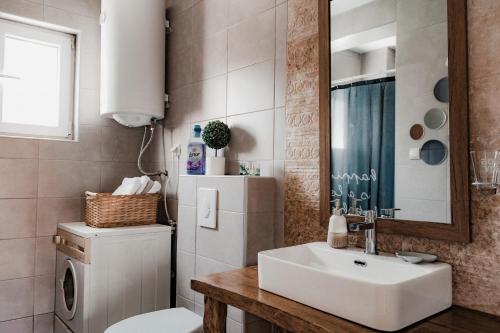 a bathroom with a white sink and a refrigerator at Zicka plaza in Kraljevo