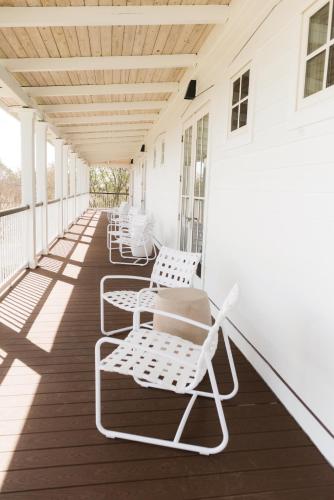 a row of chairs sitting on a porch at Oyster Bay Boutique Hotel in Pensacola