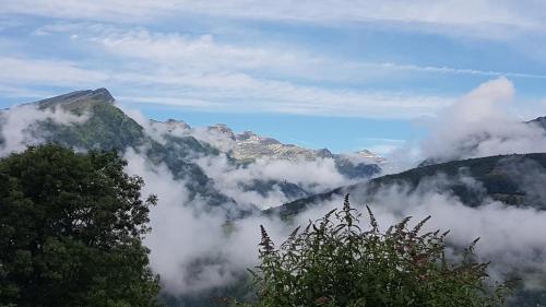 a view of a mountain valley with clouds at Ferienhaus Sonnenstrahl in Gmünd in Kärnten