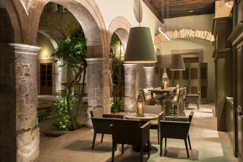 a restaurant with tables and chairs in a building at Casa Grande Hotel Boutique in Morelia