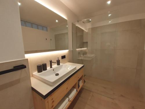 a bathroom with a sink and a shower at Haus Talblick "Wallbug" Ferienwohnung 1 in Naturno