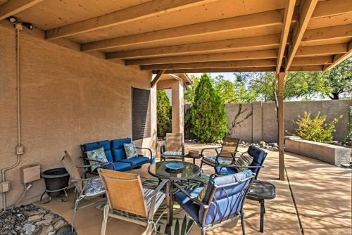 a patio with a table and chairs under awning at Charming Anthem Home with Fire Pit, 1 Mi to Park! in Anthem