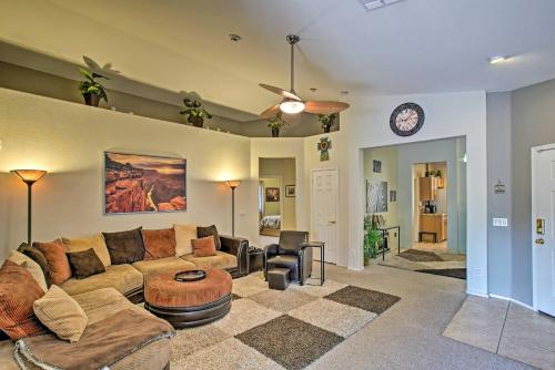 a living room with a couch and a table at Charming Anthem Home with Fire Pit, 1 Mi to Park! in Anthem