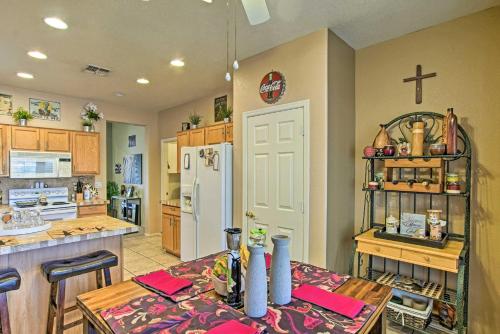 a kitchen with a table and a white refrigerator at Charming Anthem Home with Fire Pit, 1 Mi to Park! in Anthem