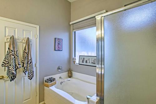 a bathroom with a bath tub and a shower at Charming Anthem Home with Fire Pit, 1 Mi to Park! in Anthem