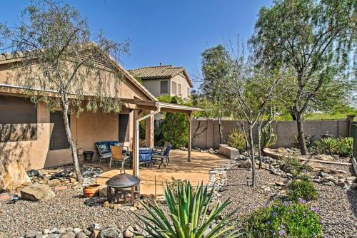 a backyard with a patio with chairs and a fence at Charming Anthem Home with Fire Pit, 1 Mi to Park! in Anthem
