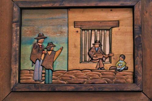 a painting of a group of people in a window at Amazilia Hotel in Pereira