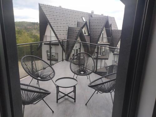 a balcony with chairs and a table on a balcony at Diamond Sunrise in Divčibare