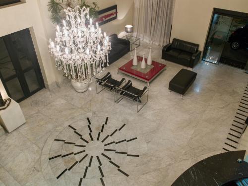 an aerial view of a living room with a chandelier at Tsue The Palace Flats in Sao Paulo