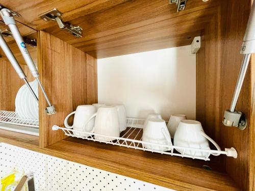 a cupboard filled with lots of white dishes at Apartments & Villa Georg in Odesa