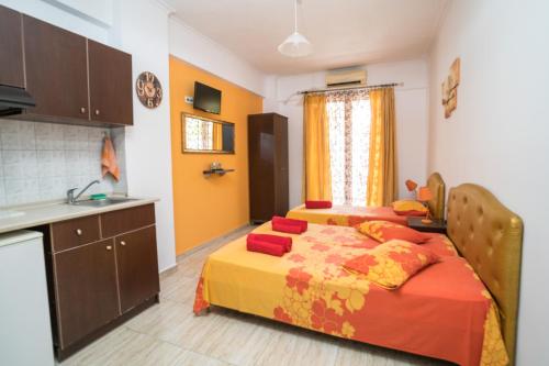 a bedroom with a bed and a kitchen with a sink at Villa Irida Sun in Olympic Beach