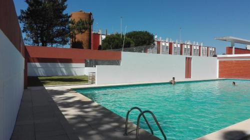 a swimming pool with a person in the water at Pérola de Viana - Cabedelo in Viana do Castelo