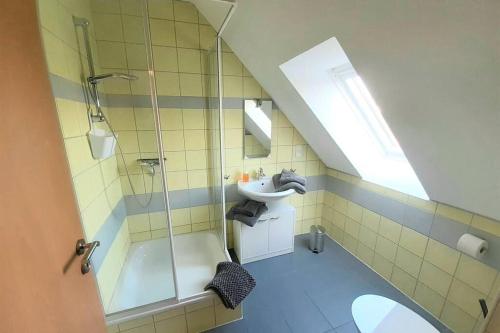 a bathroom with a glass shower and a sink at Ferienwohnung Landhaus Auf dem Hollo in Petershagen