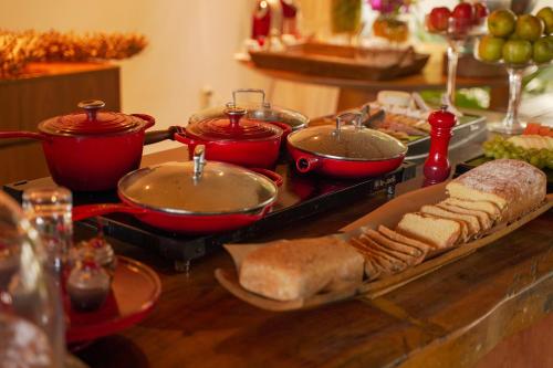 a table with several pots and pans and bread at Pousada Morena in Fernando de Noronha