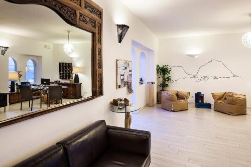 a living room with a couch and a mirror at Apollon Club & Thermal Spa in Ischia