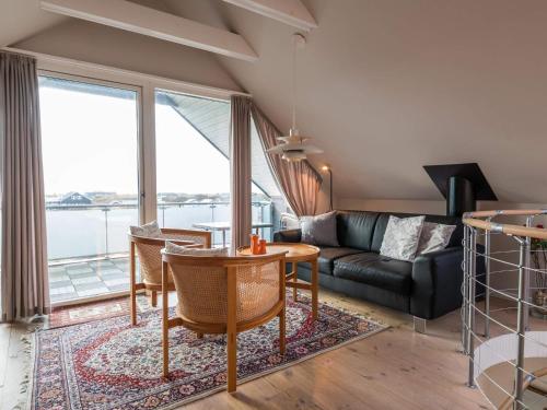 a living room with a table and a couch at Luxury Panoramic Cottage in Rindby-By Traum in Fanø