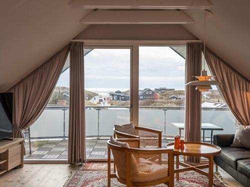 a living room with a view of the water at Luxury Panoramic Cottage in Rindby-By Traum in Fanø