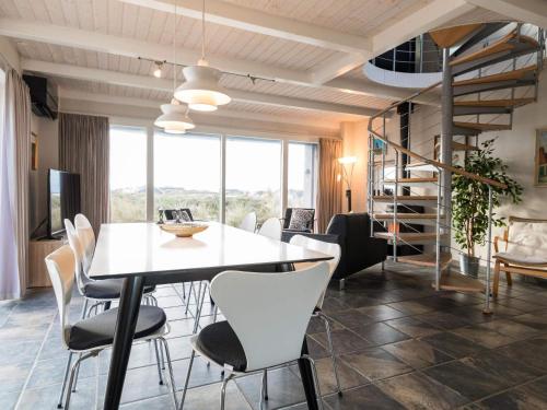 a dining room with a white table and chairs at Luxury Panoramic Cottage in Rindby-By Traum in Fanø