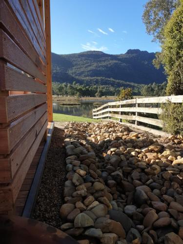 a rock retaining wall next to a building at Halls Gap Motel in Halls Gap