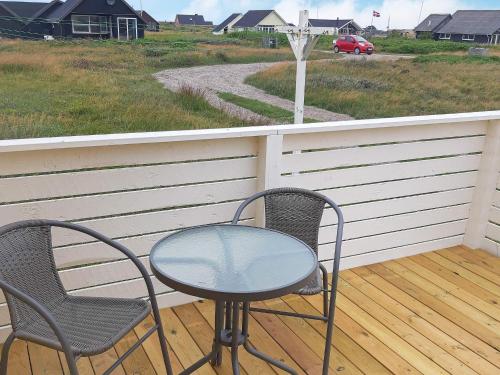 two chairs and a glass table on a porch at 5 person holiday home in Lemvig in Lemvig