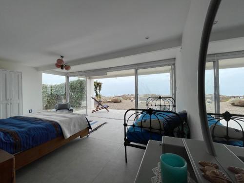 a bedroom with two beds and a large window at BIG SOTO HAUS in Totoralillo