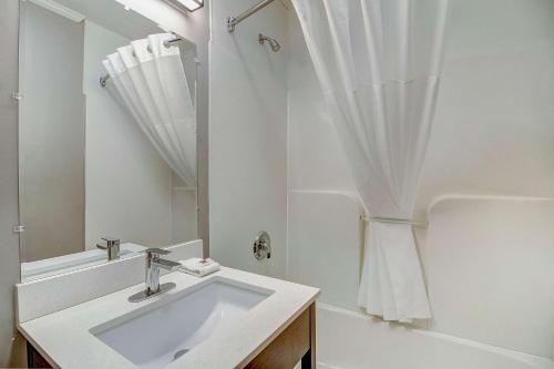 a white bathroom with a sink and a mirror at Motel 6-Front Royal, VA in Front Royal