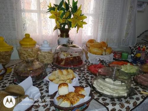a table with many different types of food on it at Pousada Oca Porã in Conservatória
