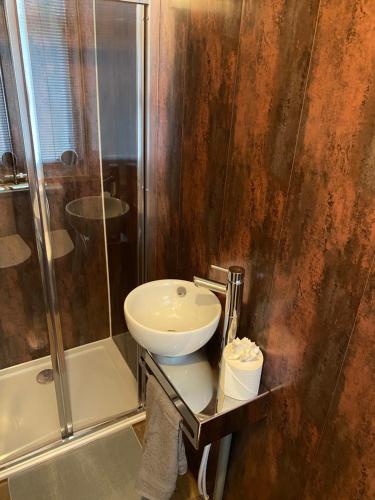 a bathroom with a sink and a shower at Glasgow City Centre Apartment in Glasgow