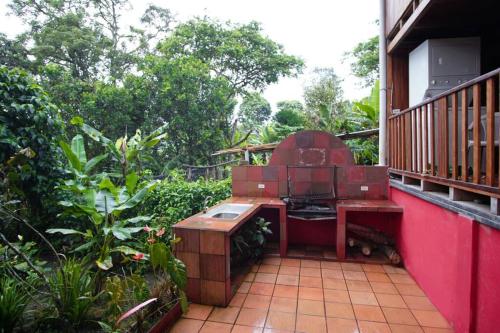 a outdoor grill on a balcony of a house at Mindo cozy house in Mindo