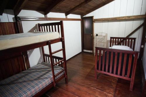 a room with two bunk beds and a chair at Mindo cozy house in Mindo