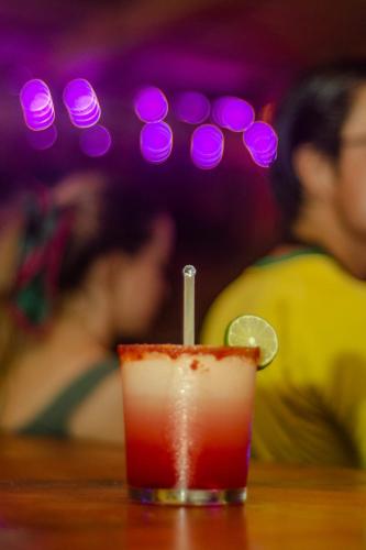 a drink sitting on top of a wooden table at La Máxima & LGBT in Zipolite