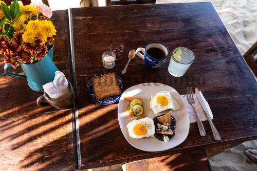 a plate of eggs and toast on a table at La Máxima & LGBT in Zipolite