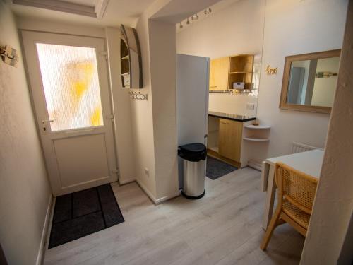 a small kitchen with a table and a window and a door at North Bay Holiday Apartment with Internet, Smart TV's and Patio Area in Scarborough