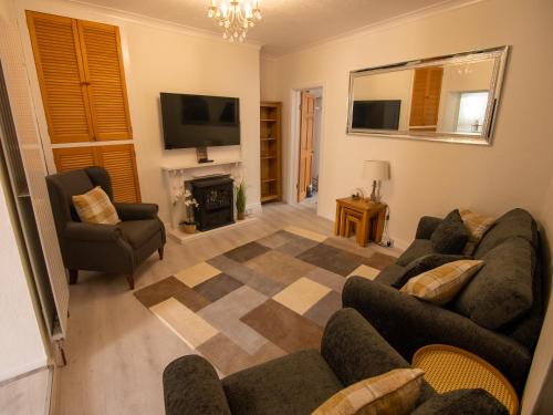 a living room with two couches and a fireplace at North Bay Holiday Apartment with Internet, Smart TV's and Patio Area in Scarborough